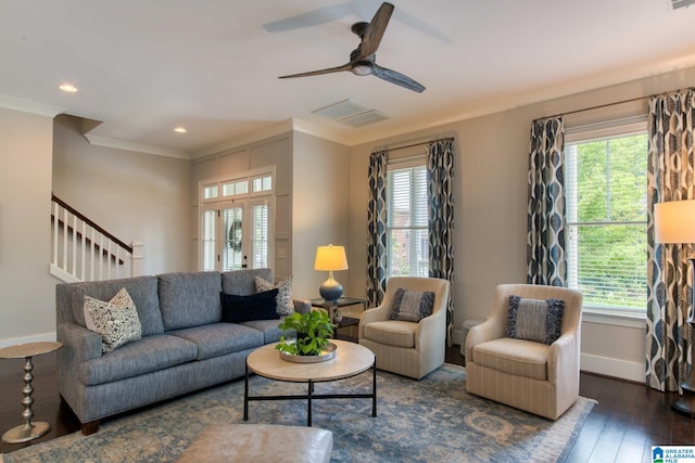 living room featuring ornamental molding, dark wood-type flooring, a healthy amount of sunlight, and ceiling fan