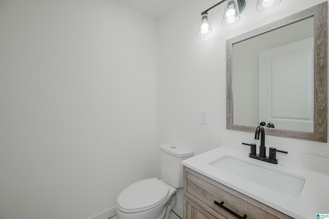 half bathroom featuring toilet and vanity