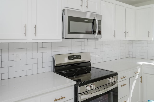 kitchen with stainless steel appliances, white cabinets, and decorative backsplash