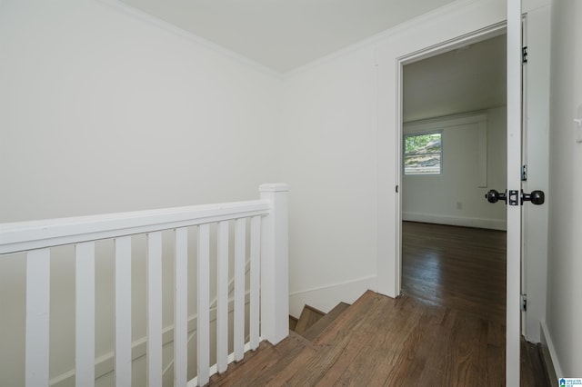 hall with crown molding, baseboards, an upstairs landing, and wood finished floors