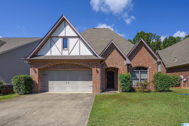 tudor-style house with a garage and a front yard