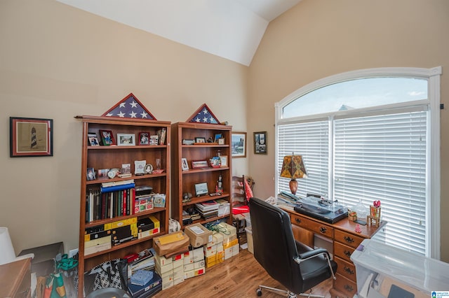 office space with light hardwood / wood-style flooring and vaulted ceiling