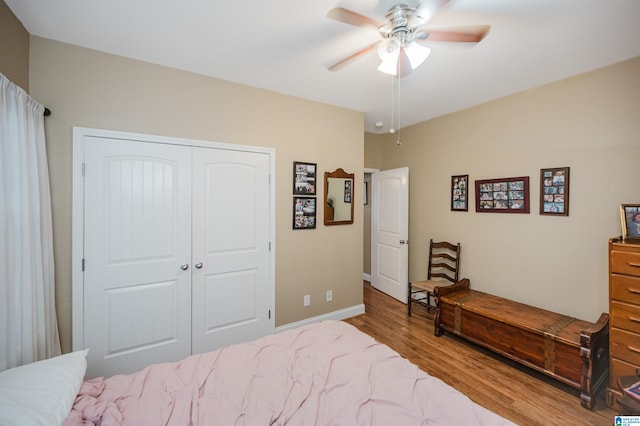 bedroom with a closet, ceiling fan, and wood-type flooring