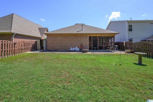 rear view of house featuring a patio area and a lawn