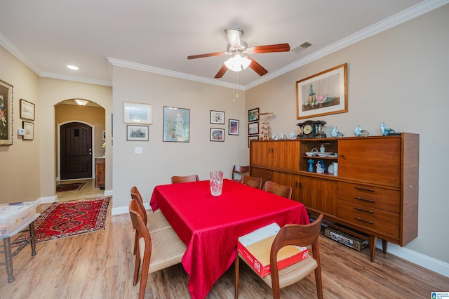 dining area featuring light hardwood / wood-style floors, ceiling fan, and ornamental molding