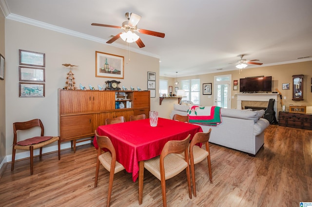 dining space featuring hardwood / wood-style floors, ceiling fan, and ornamental molding