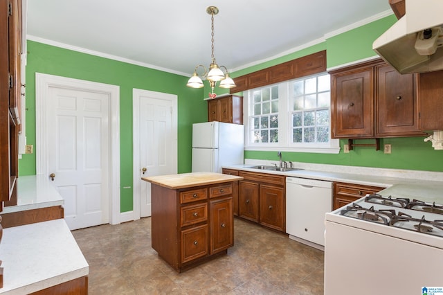 kitchen with pendant lighting, sink, white appliances, range hood, and a center island