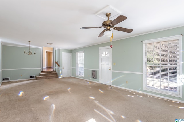 unfurnished living room featuring ceiling fan with notable chandelier and crown molding