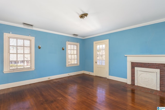 unfurnished living room featuring ornamental molding, a fireplace, hardwood / wood-style floors, and a healthy amount of sunlight