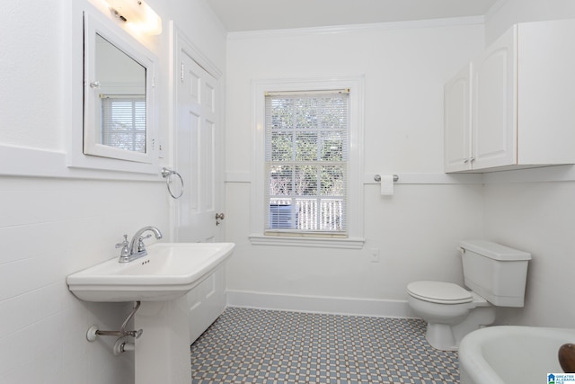 bathroom with tile walls, crown molding, and toilet