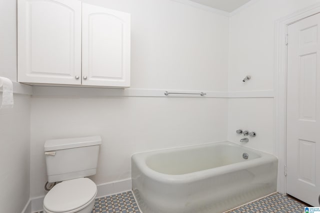 bathroom with ornamental molding, toilet, and a bathing tub