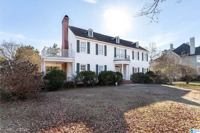 colonial house featuring a balcony