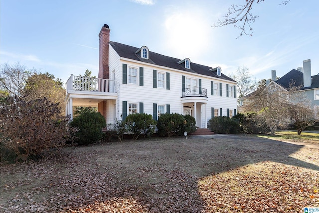 305 S St E, Talladega, AL 35160 - view of front of house featuring a chimney and a balcony