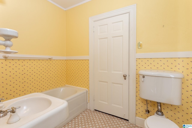 bathroom featuring ornamental molding, tile patterned flooring, a washtub, and toilet