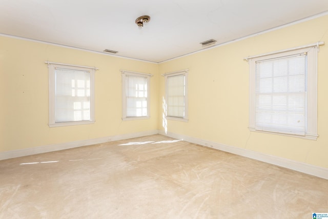 305 S St E, Talladega, AL 35160 - spare room featuring ornamental molding, visible vents, baseboards, and carpet flooring