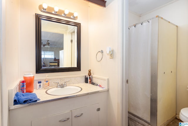 bathroom featuring ornamental molding, ceiling fan, vanity, and toilet