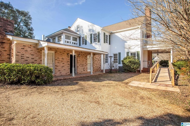 305 S St E, Talladega, AL 35160 - rear view of property with brick siding, a chimney, and central AC unit