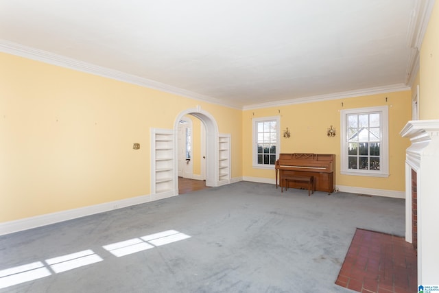305 S St E, Talladega, AL 35160 - living area featuring baseboards, arched walkways, ornamental molding, carpet floors, and a fireplace with flush hearth