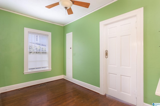 empty room with ceiling fan, dark hardwood / wood-style floors, and ornamental molding