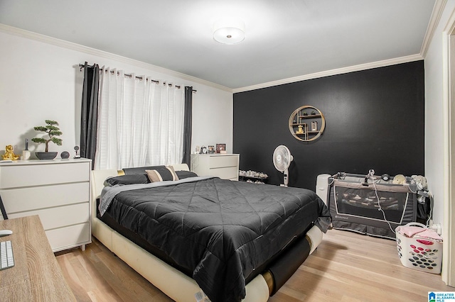 bedroom featuring crown molding and light wood-type flooring