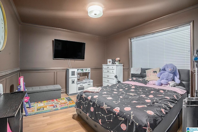 bedroom with light hardwood / wood-style floors and ornamental molding