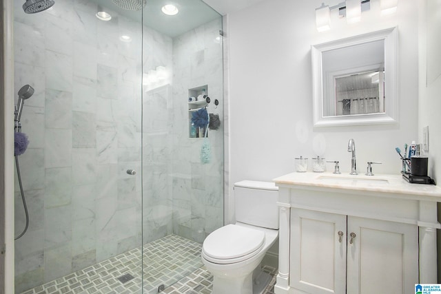 bathroom featuring vanity, toilet, and walk in shower