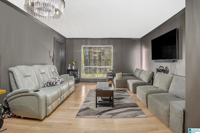 living room featuring crown molding and light hardwood / wood-style flooring