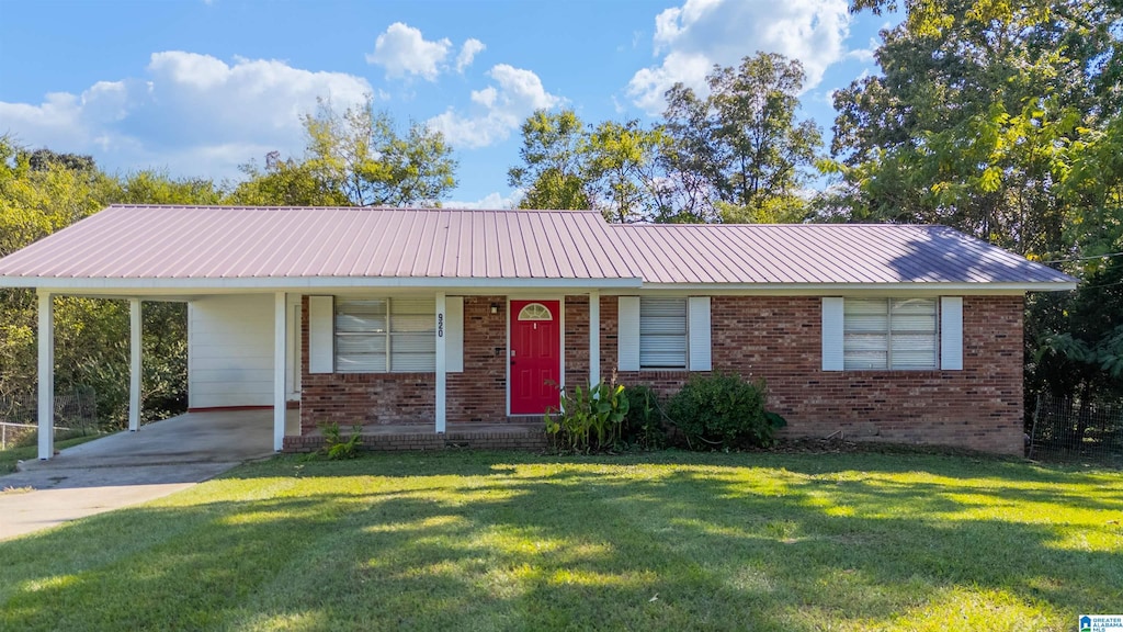 single story home with a front lawn, a carport, and covered porch