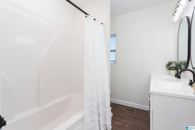 bathroom with vanity, hardwood / wood-style flooring, and shower / tub combo