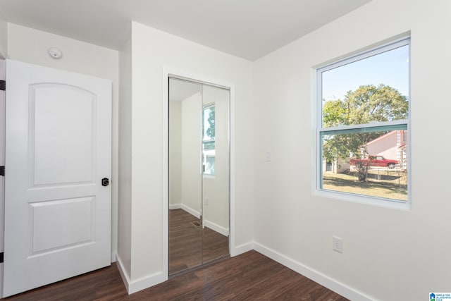 hallway with dark hardwood / wood-style floors