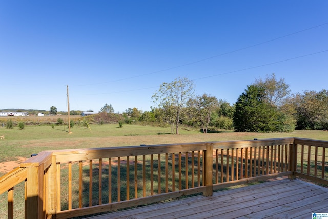 wooden terrace featuring a yard and a rural view