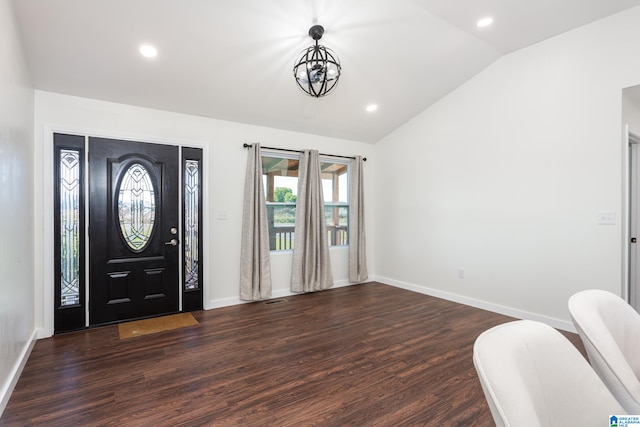 entryway featuring an inviting chandelier, dark wood-type flooring, and vaulted ceiling