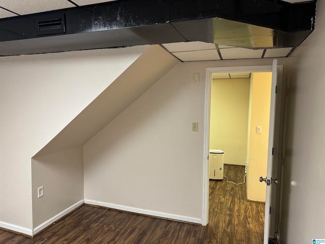 additional living space featuring dark wood-type flooring