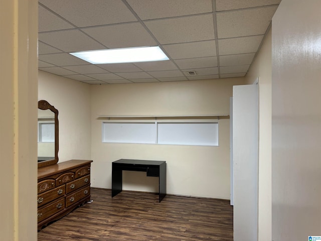 office featuring a drop ceiling and dark wood-type flooring