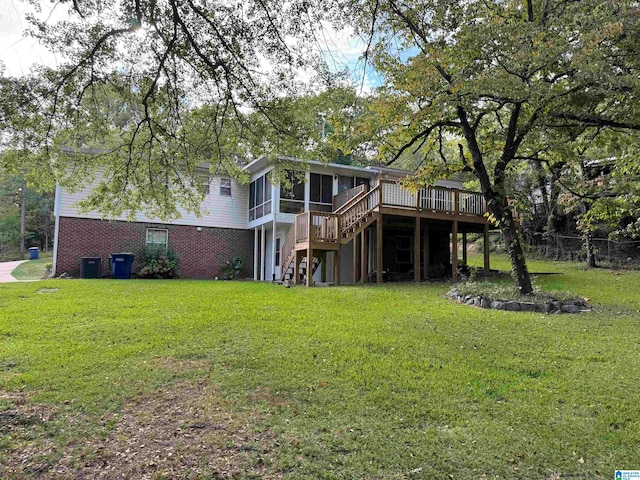 back of house with a deck and a yard