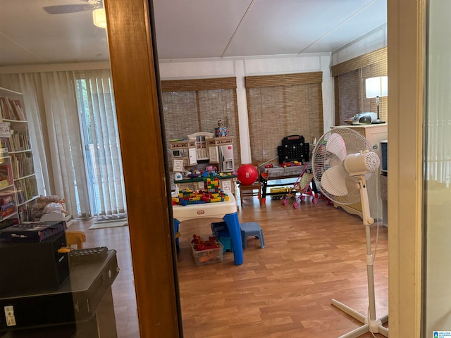 interior space featuring wood-type flooring and ceiling fan