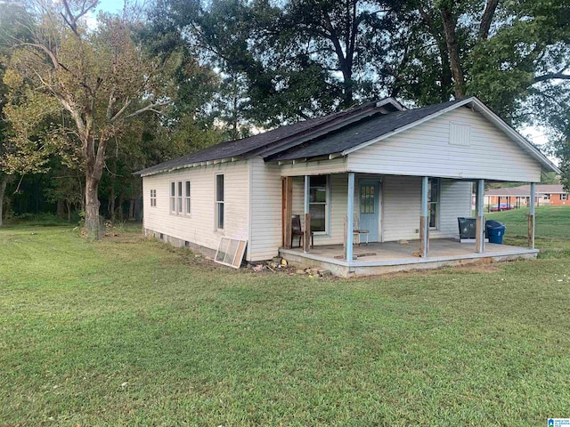 view of front of house with a front yard and a porch