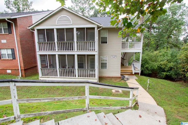 view of front of property with a front yard and a sunroom