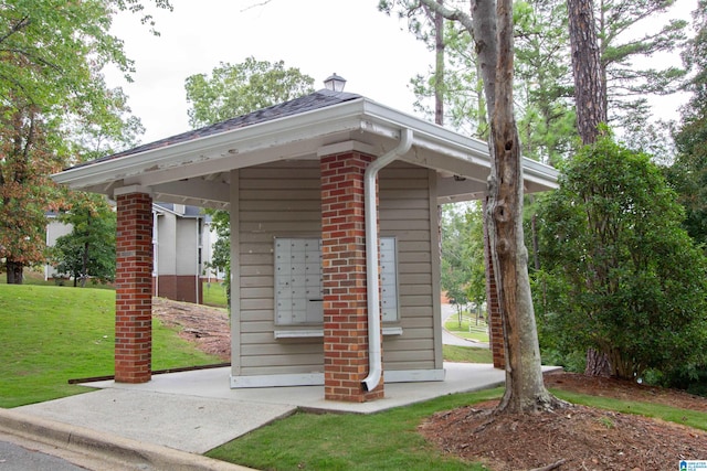 view of property's community featuring a lawn, mail boxes, and a gazebo