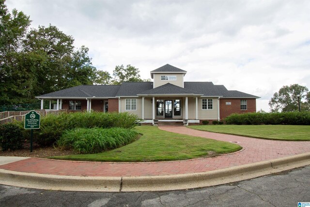 view of front facade featuring a front lawn and covered porch