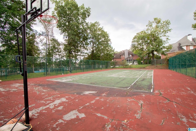 view of tennis court with basketball hoop