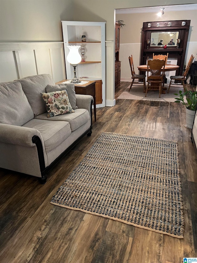 living room with dark hardwood / wood-style floors and ornamental molding