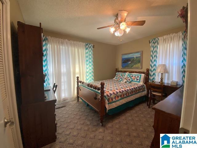 carpeted bedroom with a ceiling fan