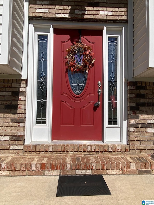 property entrance with brick siding