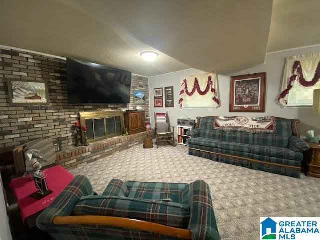 carpeted living area featuring a brick fireplace