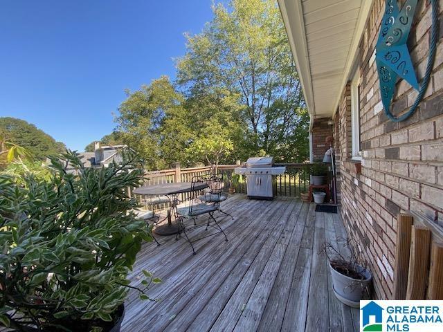 deck with outdoor dining space and area for grilling