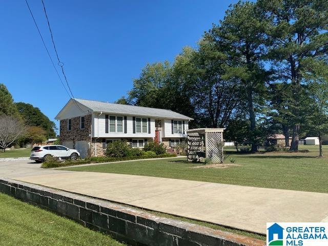 bi-level home with a front lawn
