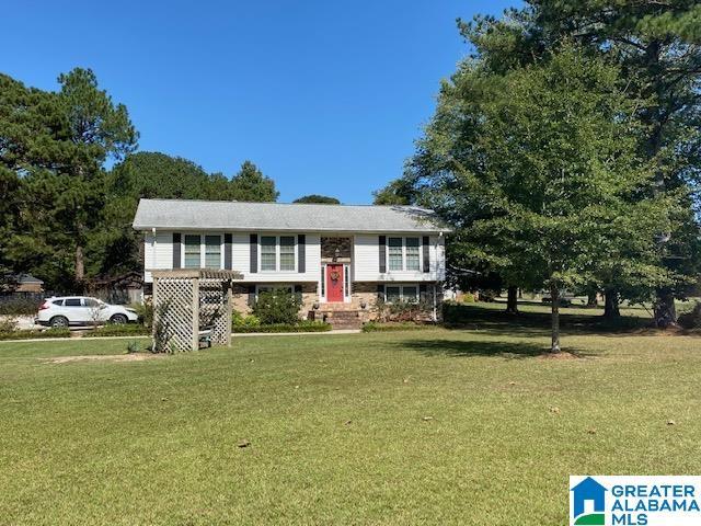 bi-level home with a front lawn