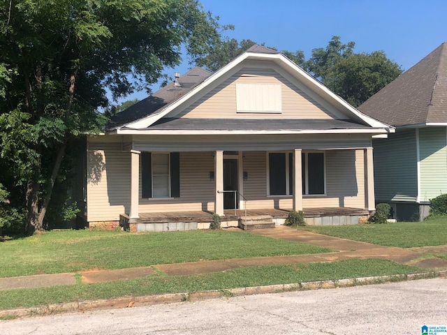 bungalow with a front lawn and a porch