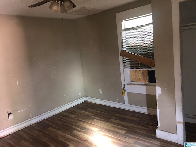 unfurnished room featuring ceiling fan and dark hardwood / wood-style floors